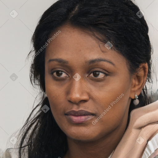 Joyful black young-adult female with long  black hair and brown eyes