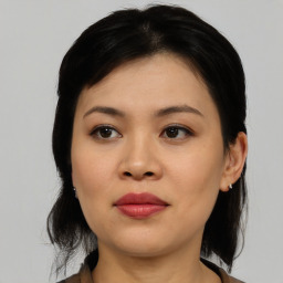 Joyful asian young-adult female with medium  black hair and brown eyes