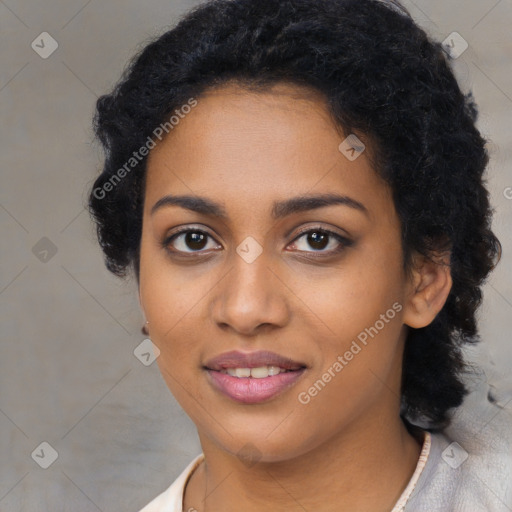 Joyful black young-adult female with long  black hair and brown eyes