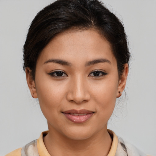 Joyful latino young-adult female with medium  brown hair and brown eyes