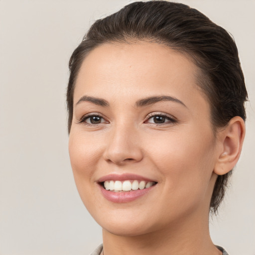 Joyful white young-adult female with medium  brown hair and brown eyes