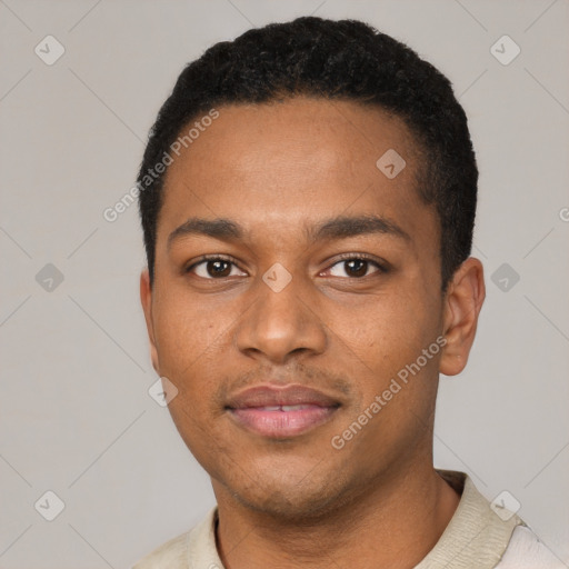 Joyful black young-adult male with short  black hair and brown eyes