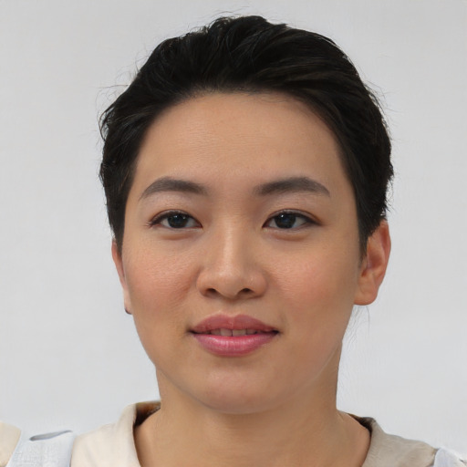 Joyful asian young-adult female with short  black hair and brown eyes