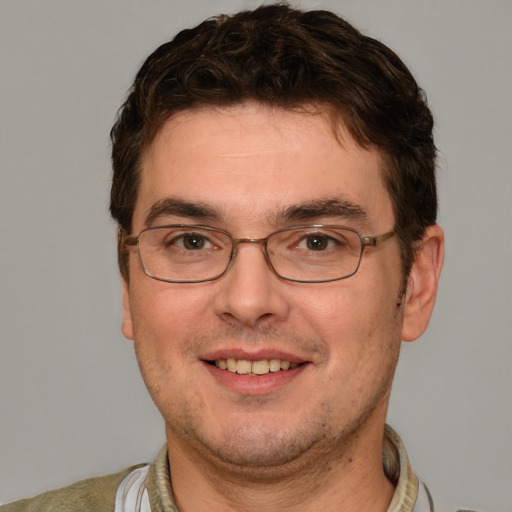 Joyful white adult male with short  brown hair and brown eyes