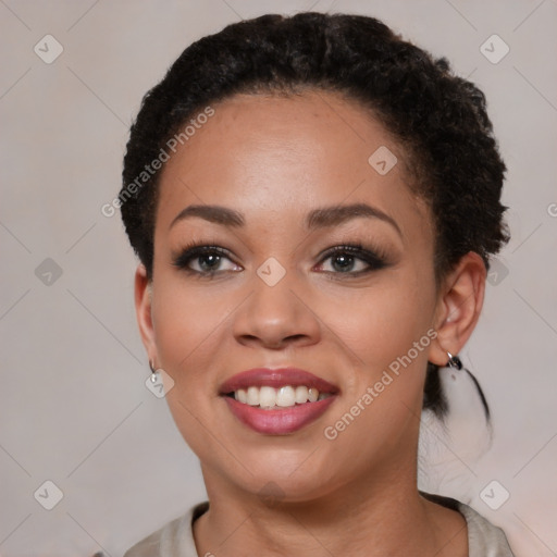 Joyful black young-adult female with short  brown hair and brown eyes