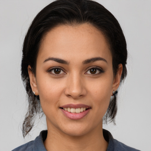 Joyful white young-adult female with medium  brown hair and brown eyes