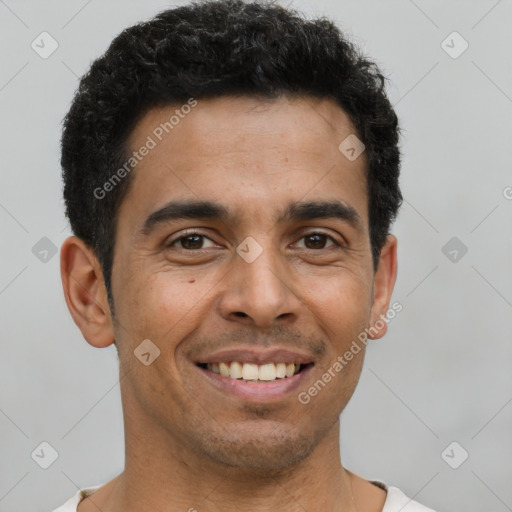 Joyful latino young-adult male with short  black hair and brown eyes