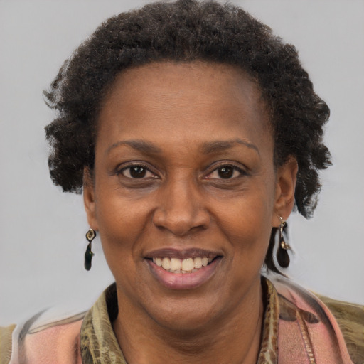 Joyful black adult female with short  brown hair and brown eyes