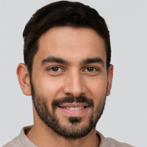 Joyful white young-adult male with short  brown hair and brown eyes