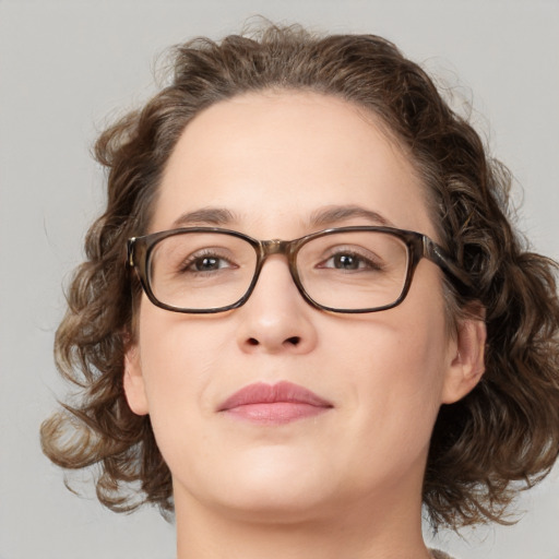 Joyful white adult female with medium  brown hair and green eyes