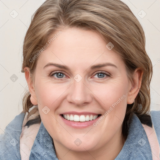 Joyful white young-adult female with medium  brown hair and blue eyes