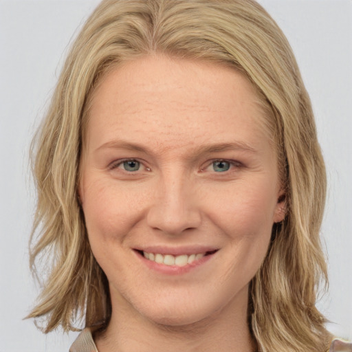 Joyful white young-adult female with medium  brown hair and blue eyes