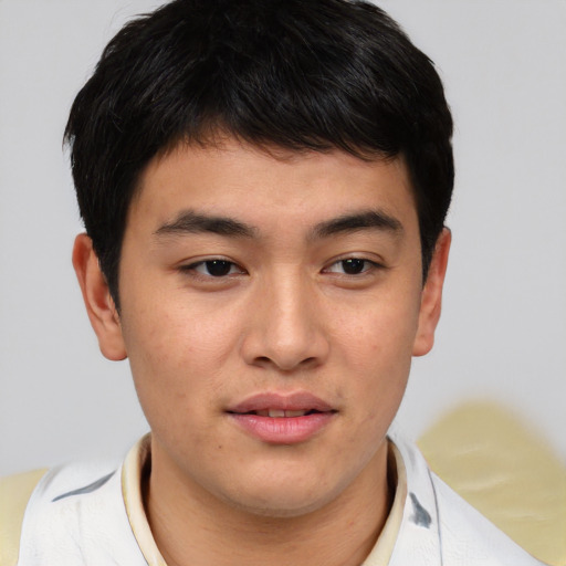 Joyful asian young-adult male with short  brown hair and brown eyes