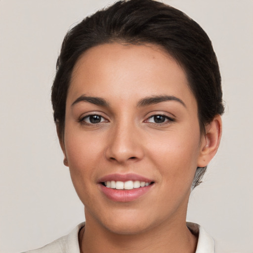 Joyful white young-adult female with short  brown hair and brown eyes