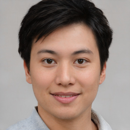 Joyful asian young-adult male with short  brown hair and brown eyes