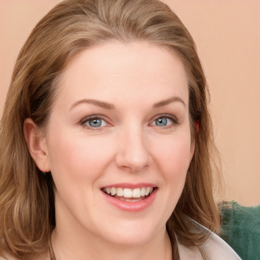 Joyful white young-adult female with long  brown hair and blue eyes