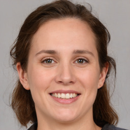 Joyful white young-adult female with medium  brown hair and grey eyes