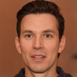 Joyful white adult male with short  brown hair and brown eyes