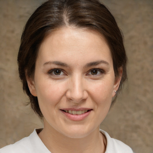 Joyful white adult female with medium  brown hair and brown eyes