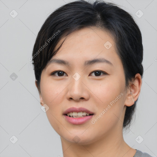 Joyful asian young-adult female with medium  black hair and brown eyes