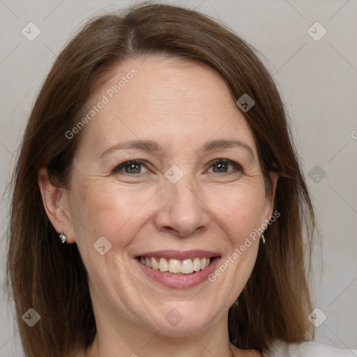 Joyful white adult female with medium  brown hair and grey eyes