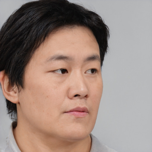 Neutral asian young-adult male with short  brown hair and brown eyes
