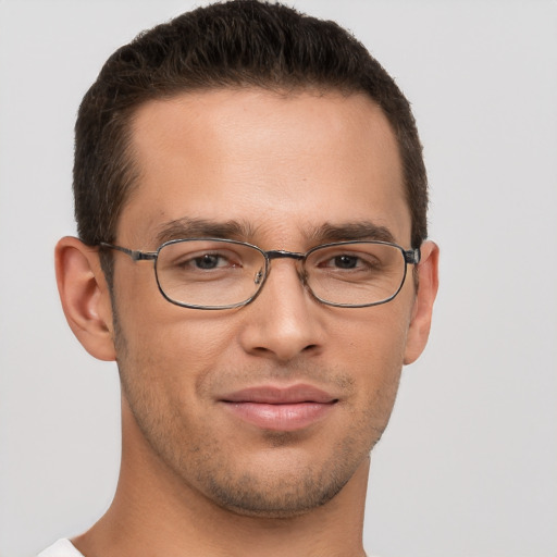 Joyful white young-adult male with short  brown hair and brown eyes