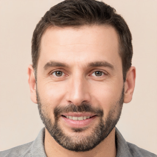 Joyful white young-adult male with short  brown hair and brown eyes