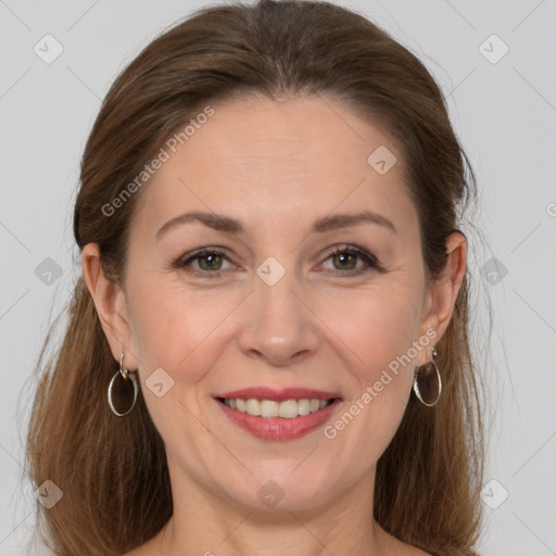 Joyful white adult female with long  brown hair and grey eyes