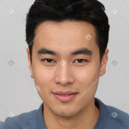 Joyful asian young-adult male with short  black hair and brown eyes