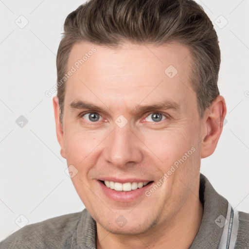 Joyful white adult male with short  brown hair and grey eyes