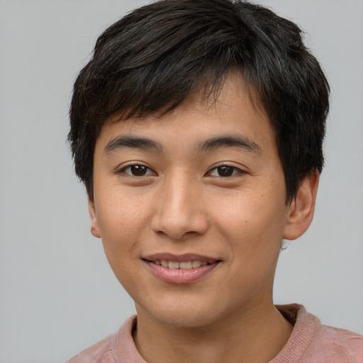 Joyful asian young-adult male with short  brown hair and brown eyes