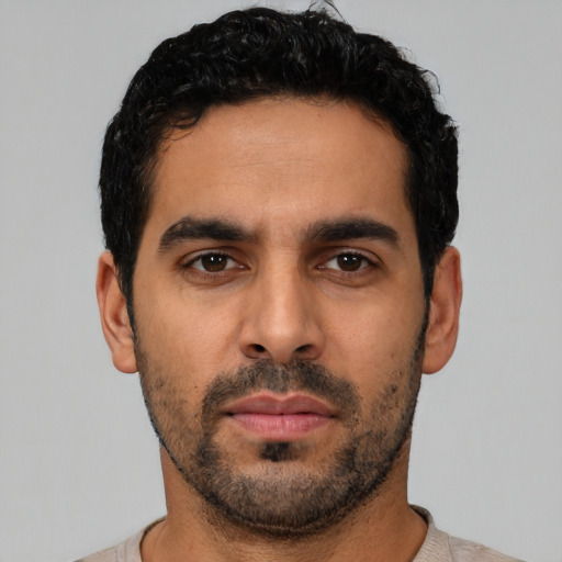 Neutral latino young-adult male with short  black hair and brown eyes