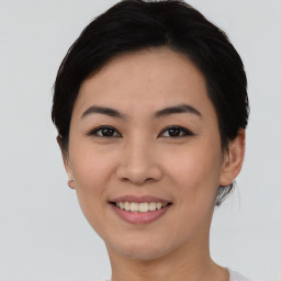 Joyful asian young-adult female with short  black hair and brown eyes