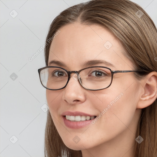 Joyful white young-adult female with long  brown hair and blue eyes