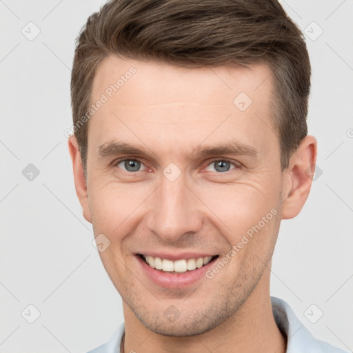 Joyful white young-adult male with short  brown hair and brown eyes