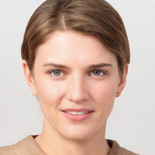 Joyful white young-adult female with short  brown hair and grey eyes