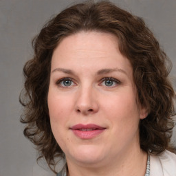 Joyful white young-adult female with medium  brown hair and green eyes