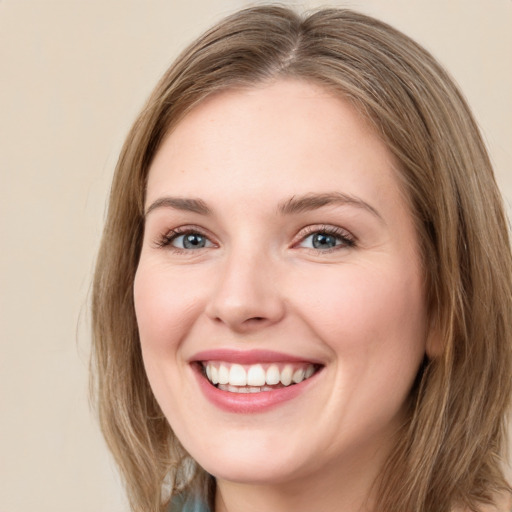 Joyful white young-adult female with medium  brown hair and green eyes