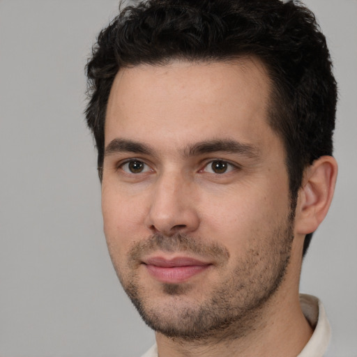 Joyful white young-adult male with short  black hair and brown eyes