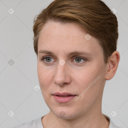 Joyful white young-adult female with short  brown hair and grey eyes