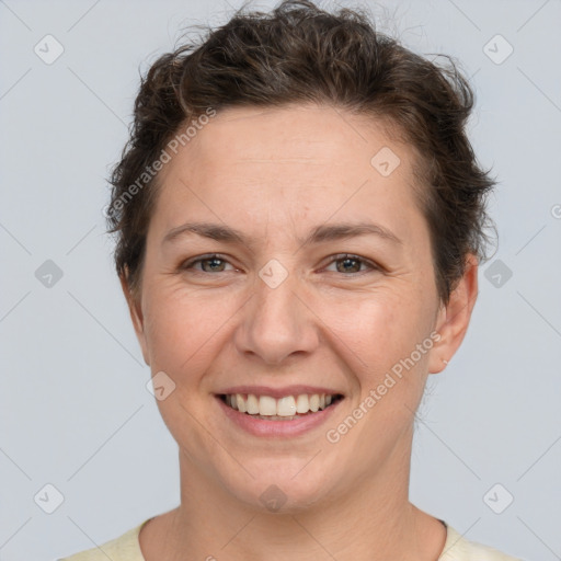 Joyful white adult female with short  brown hair and brown eyes