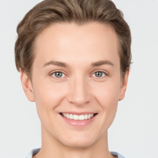 Joyful white young-adult female with short  brown hair and grey eyes