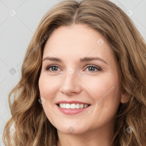 Joyful white young-adult female with long  brown hair and green eyes