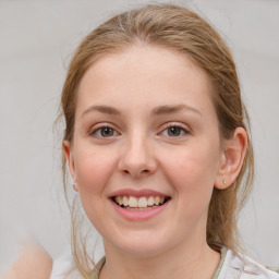 Joyful white young-adult female with medium  brown hair and blue eyes