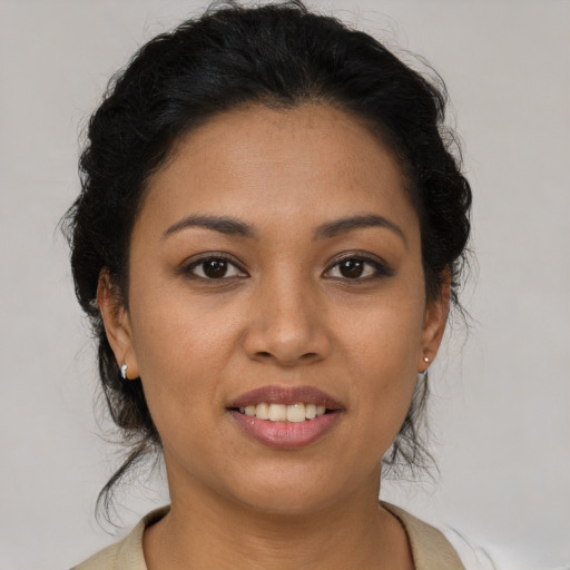 Joyful latino young-adult female with medium  brown hair and brown eyes