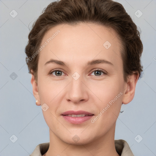 Joyful white young-adult female with short  brown hair and grey eyes