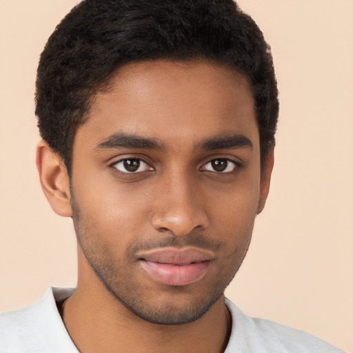 Joyful black young-adult male with short  brown hair and brown eyes