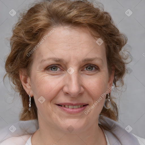 Joyful white adult female with medium  brown hair and blue eyes