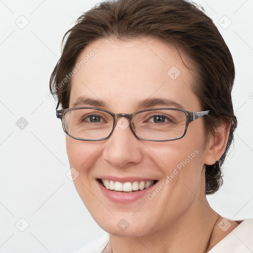 Joyful white young-adult female with short  brown hair and grey eyes